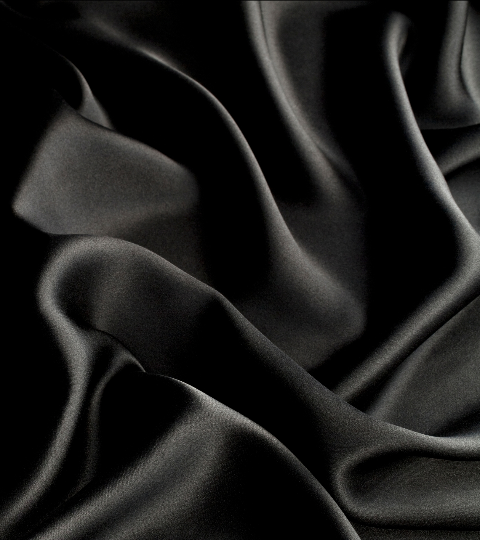 An image of the material of a black dress, symbolising a feminine area on the screen